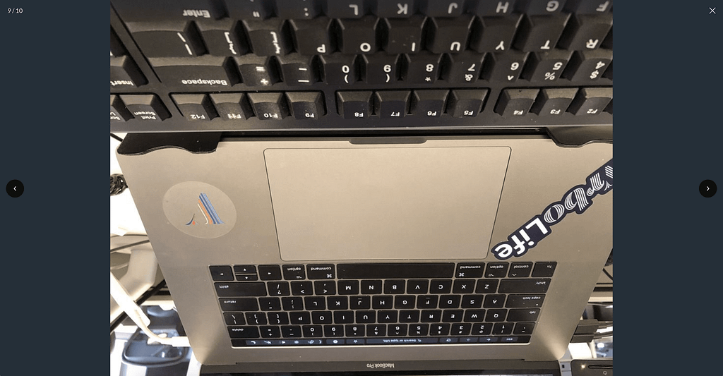 Upside-down image of a laptop computer with Vrbo stickers on it