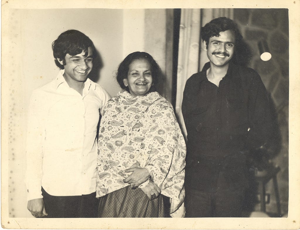 A black and white picture of three people smiling