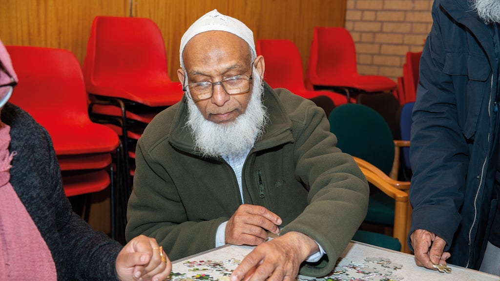 Older man doing a jigsaw puzzle