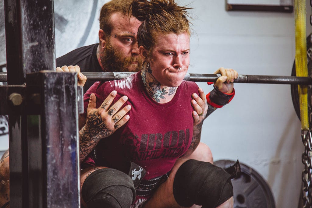 Woman lifting heavy weights.