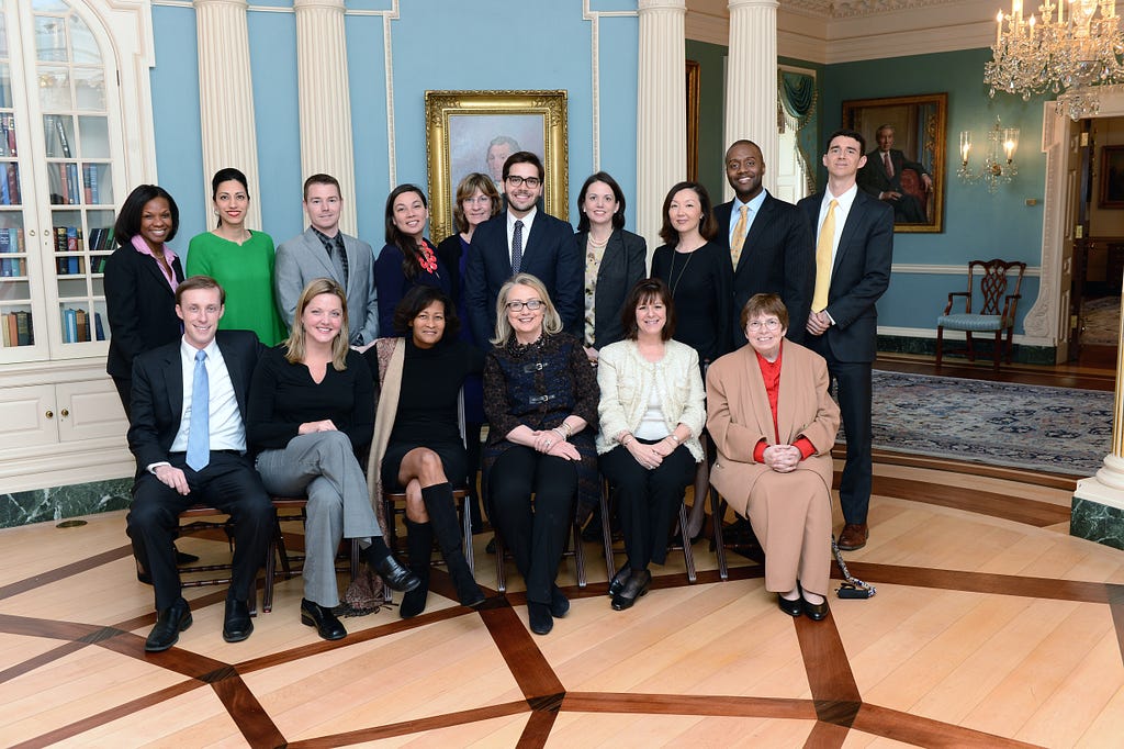 A group photo of diplomats with former Sec. of State Hillary Clinton