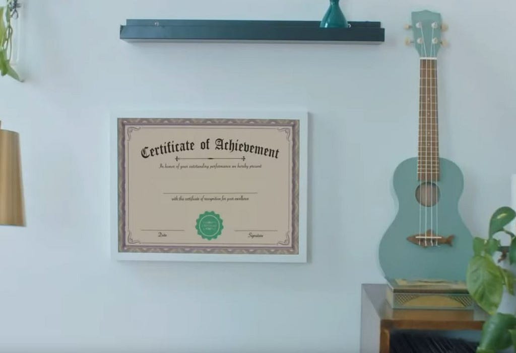 An incredibly fake looking ‘Certificate of Acheivement’ hangs next to a Ukulele, Because OF COURSE she has a ukulele. Amanda Palmer has a lot to answer for.