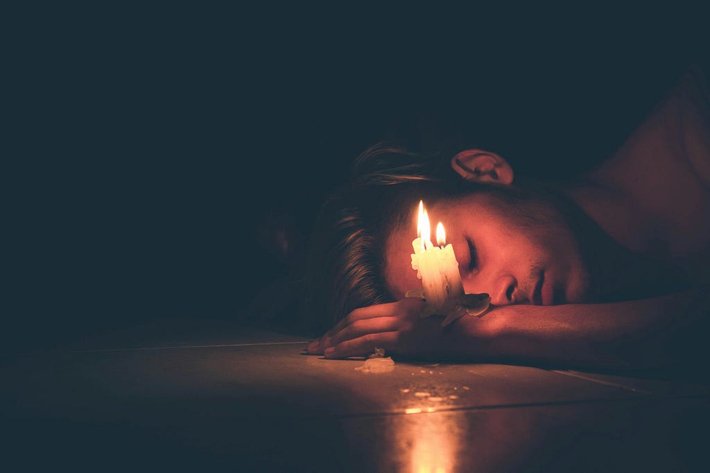 Hopleess person fallen into depression with a candle