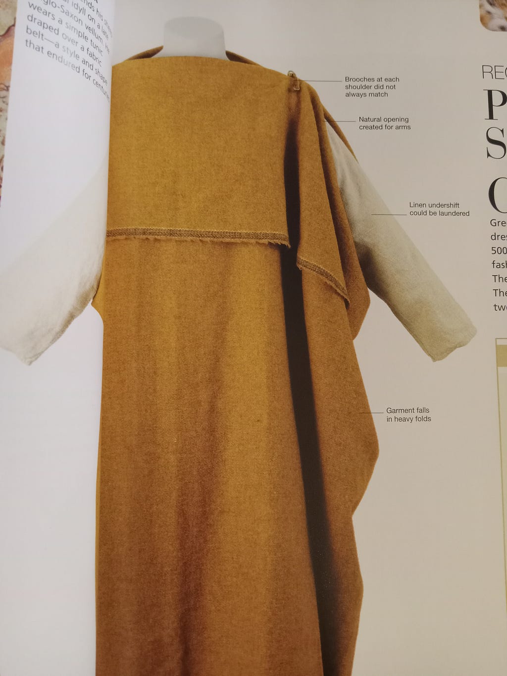 A gold peplos-style garment from the Smithsonian’s “The Definitive Visual History” book.