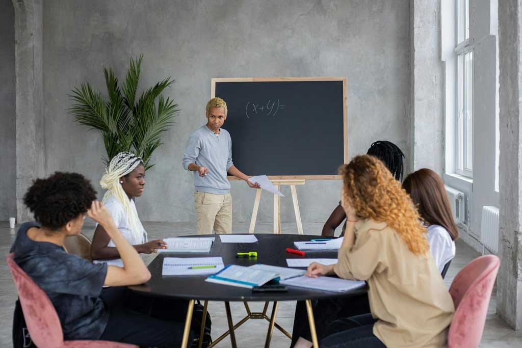 A Man teaching a group of people.