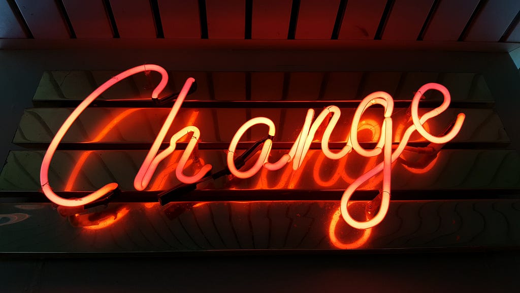 The word “change” in red neon letters