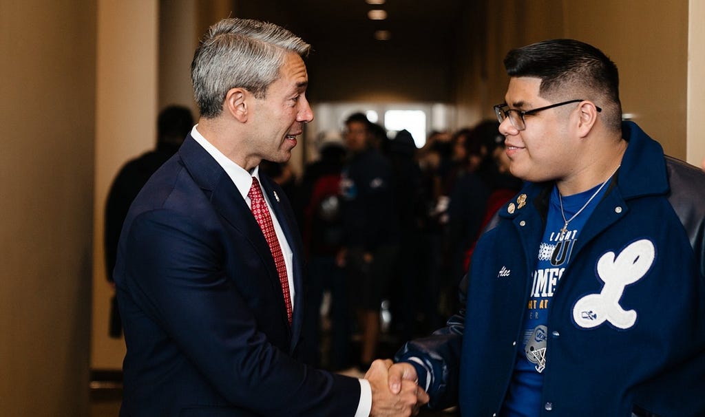 The mayor of San Antonio, Texas, shakes hand with a high school student