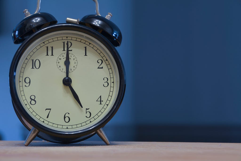 manual alarm clock showing 5 a.m.
