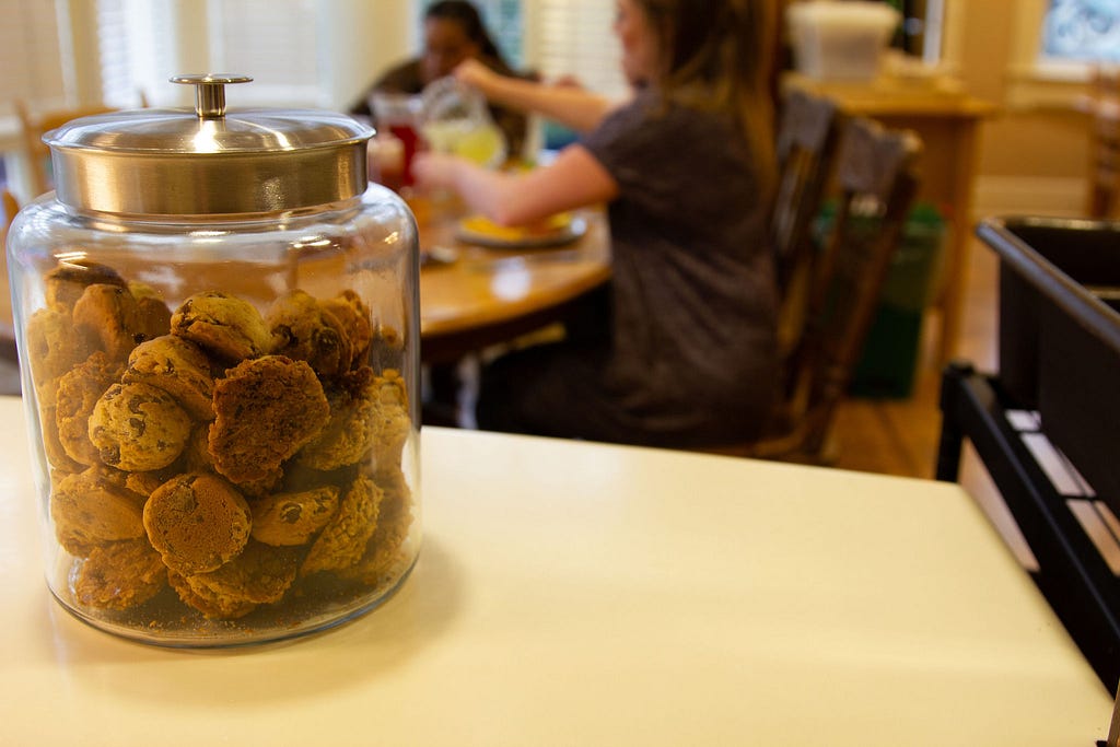 A jar of cookies sits on a counter