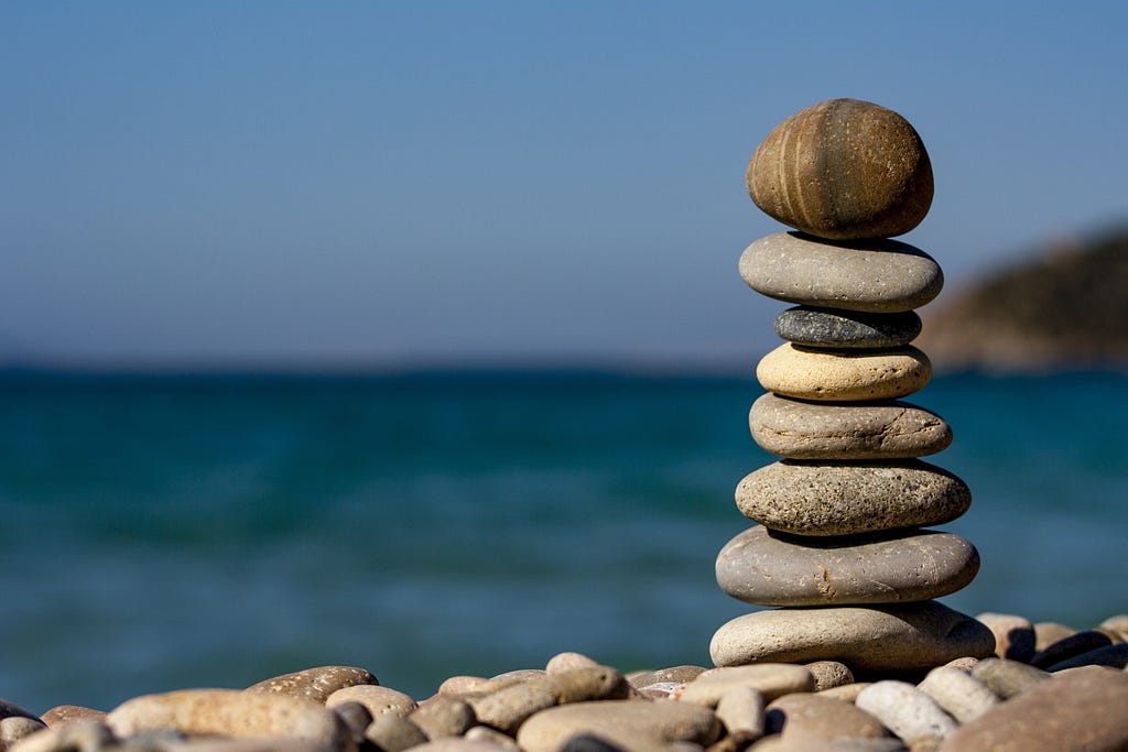 Cairn stack of pebbles with the sea in the background