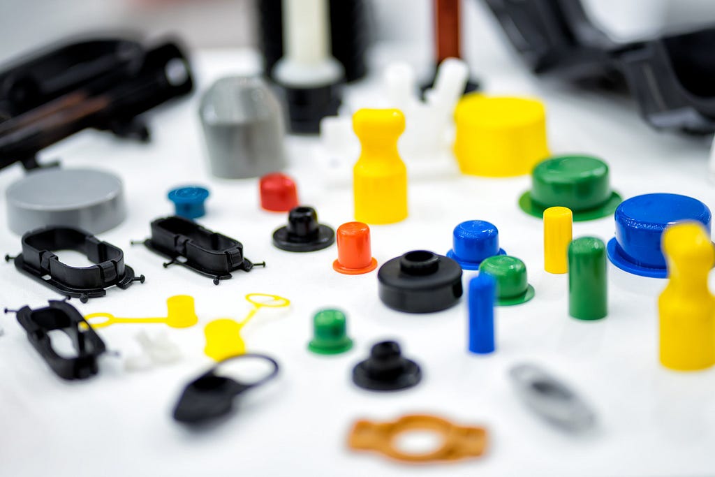 small injection molded plastic pieces of various colors and materials