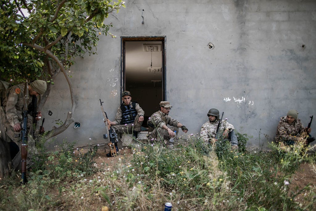 Government of National Accord (GNA) fighters rest in an abandoned farm in Ain Zara frontline in Tripoli. Amru Salahuddien, Libya A Fight for the Capital, April 2019 — May 2020