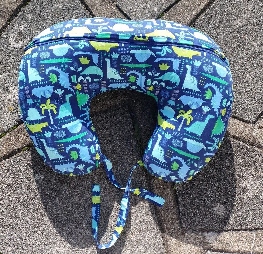 A blue breastfeeding pillow on the ground