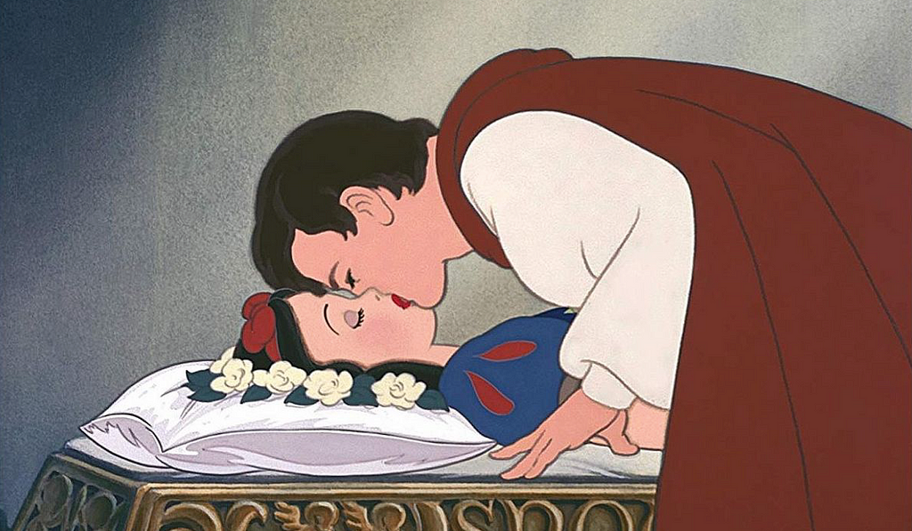 The prince kissing the sleeping Snow White, to break the spell.