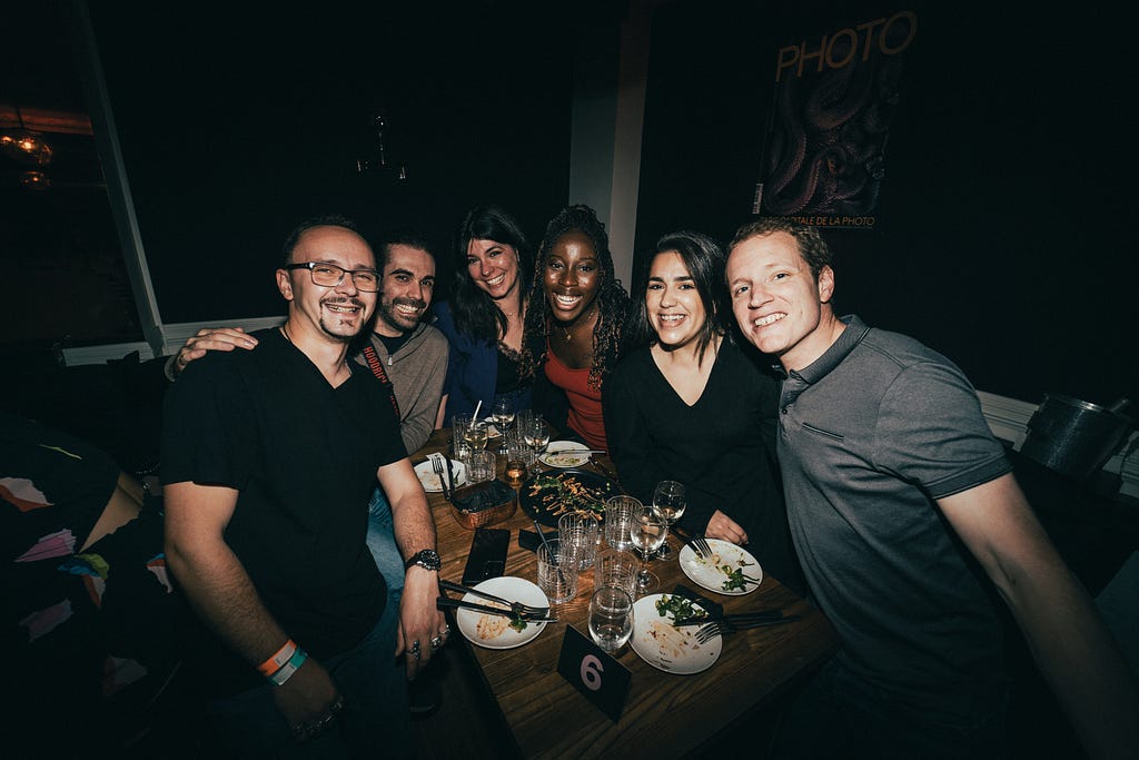 Six strangers at a Timeleft dinner posing for a group photo at the end of their meal.