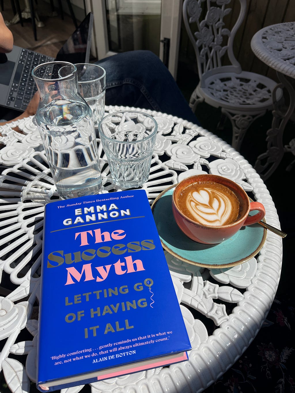 Success myth book on a table with a coffee in the sunshine