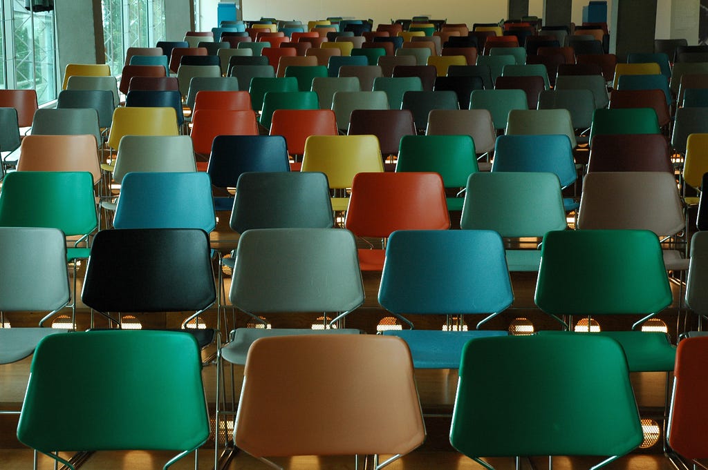 Empty lecture hall with many colorful chairs