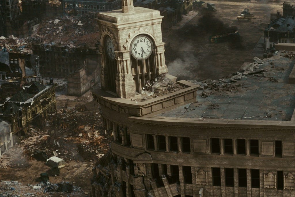 Screenshot of a destroyed cityscape with a barely standing clock tower, showing the aftermath of Godzilla passing through and wreaking havoc.