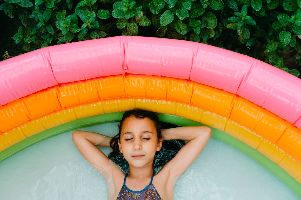 Girl lying down in an inflatable pool and relaxing