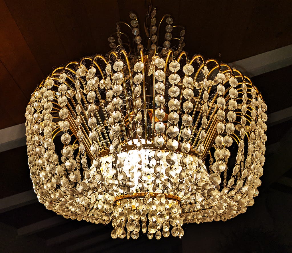 The crystal chandelier that the writer bought in Prague and carried home like a piece of airline luggage. When she moved from the Victorian home in San Francisco, she took it to her new Mid-Century Modern home in Marin County. (photo © April Orcutt)