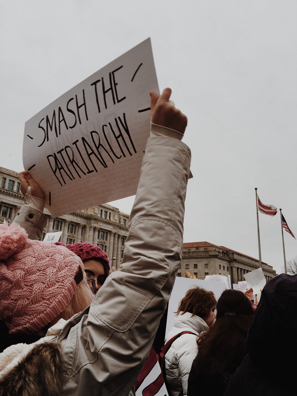 A protester with a sign saying “smash the patriarchy”