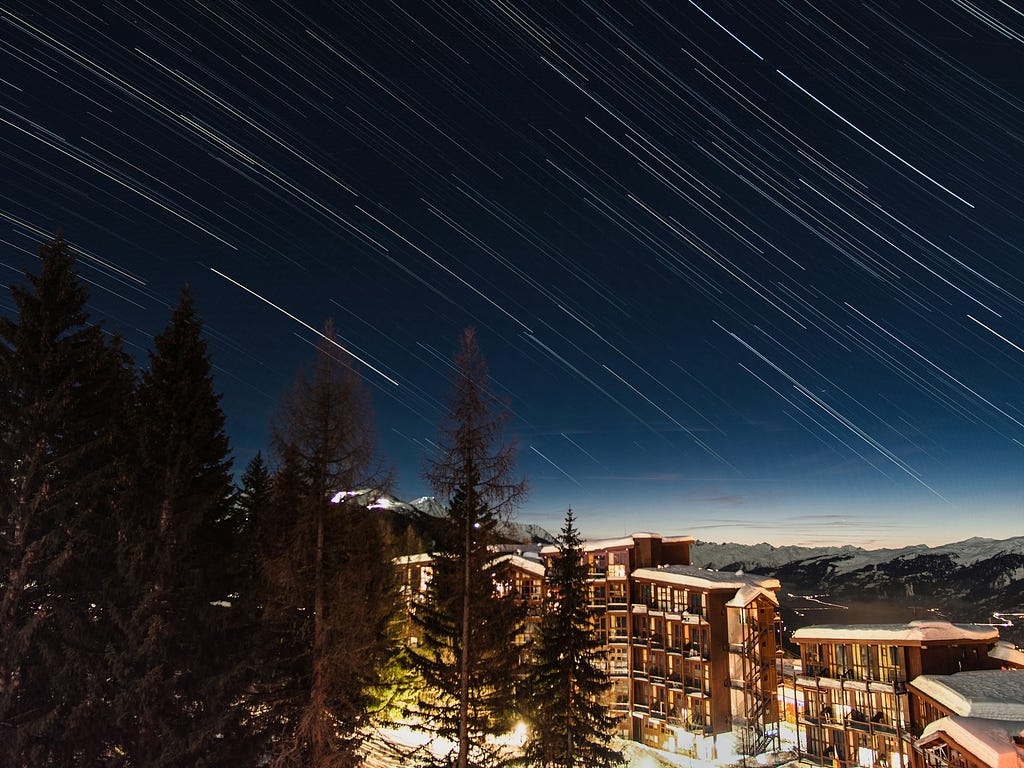 Meteor rain over snowy landscape