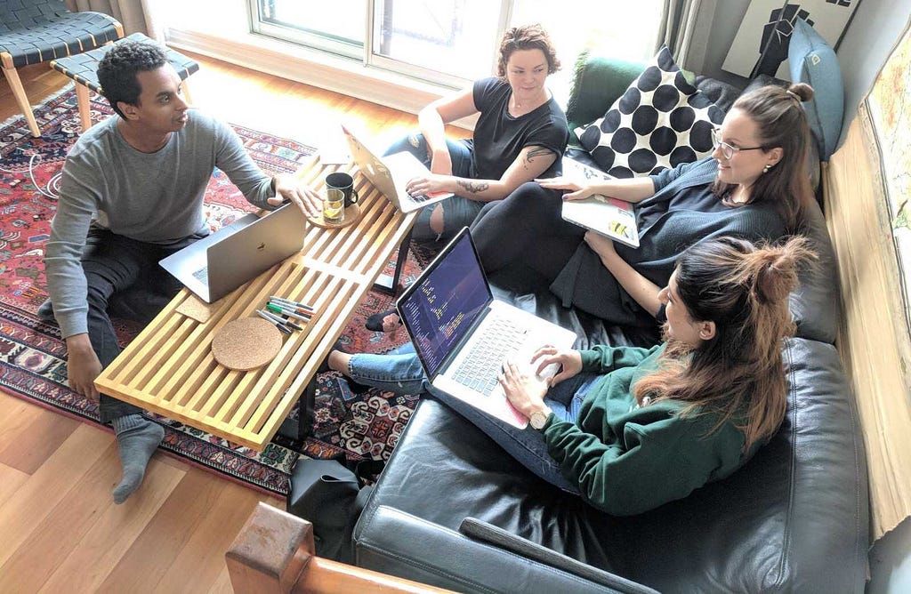 Four people working around a table.