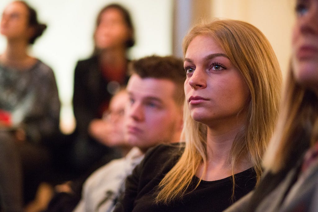 Photo of a woman in the audience at a crypto conference.