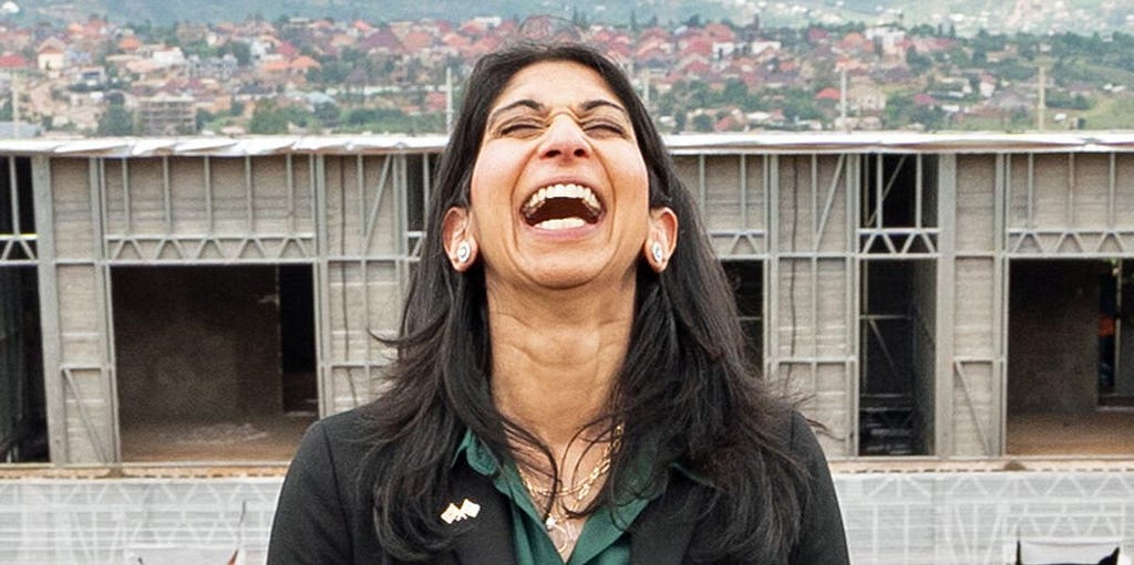 Image of Suella Braverman in front of the concentration camps she had built, laughing like a fucking drain.