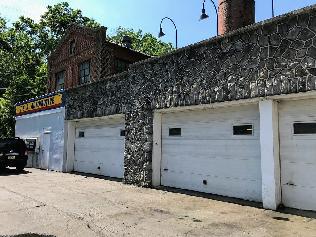 stone facing around 3 closed bays at an auto repair shop