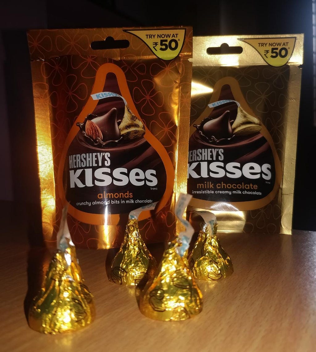 two packets of hershey,’s kisses chocolate pouch.