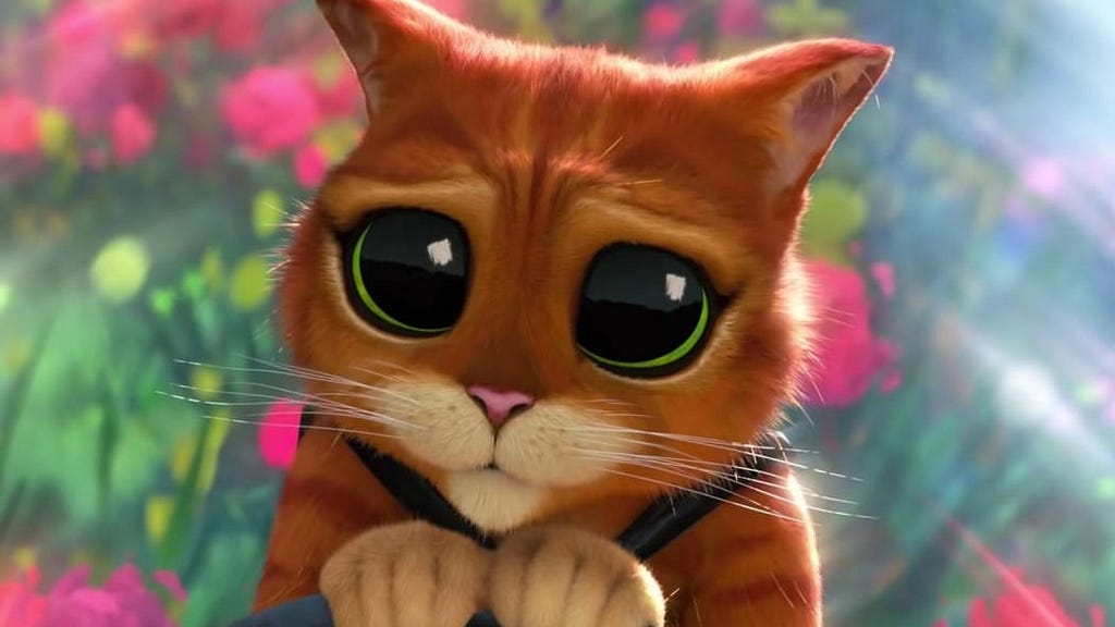 A still frame of Puss in Boots in his iconic “cute, big eyes” pose