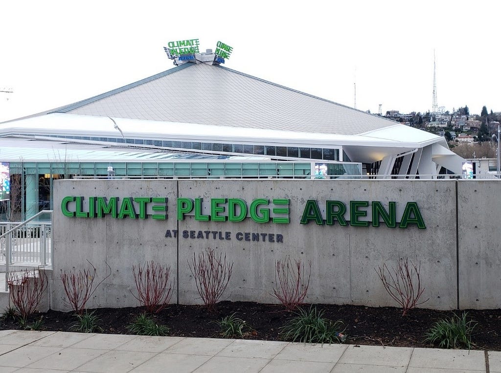 Street-level view of the arena’s south facade at the Seattle Center ‘s downtown campus on a gray cloudy day.