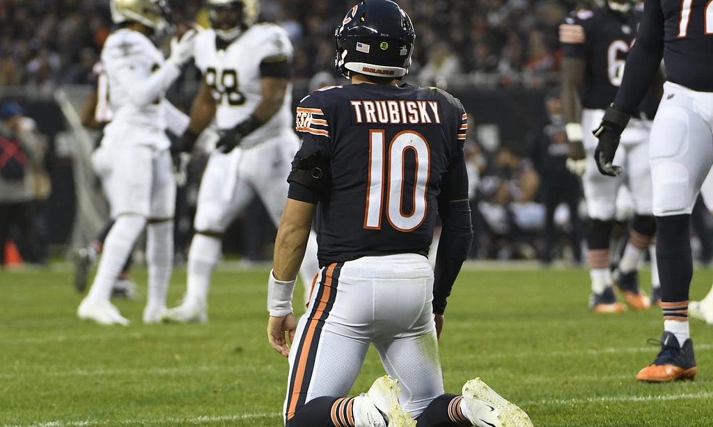 Bears quarterback Mitch Trubisky stares toward celebrating opponents from his knees on Sunday at Soldier Field.