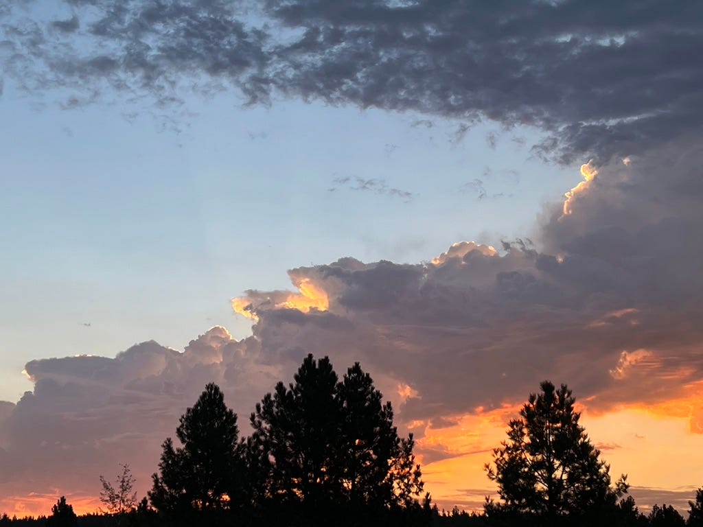 Sunrise on August 13, 2022 at 5:50 (AM). Varying intensities of light and color change the perspective of the light source as you ascend up the photograph.