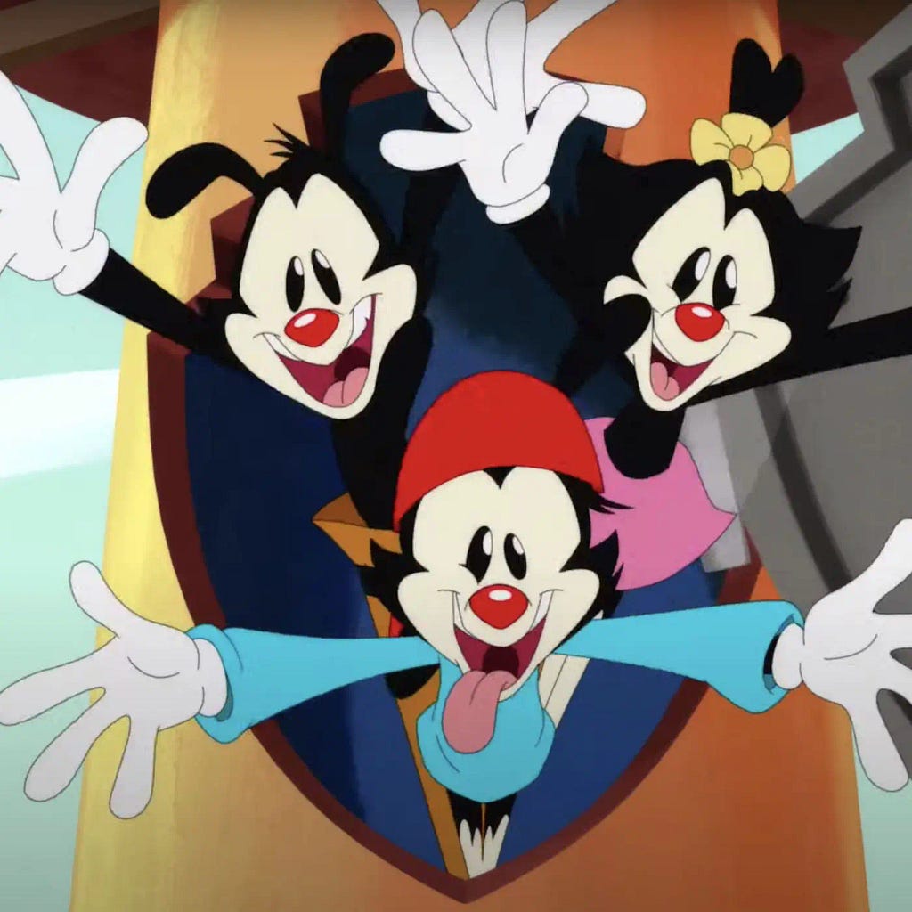 A frame from the 2018 reboot of the Animaniacs, showing the three Warner siblings and their intentional homages to earlier, black-and-white cartoons.