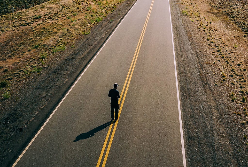 Man Walking on an empty road