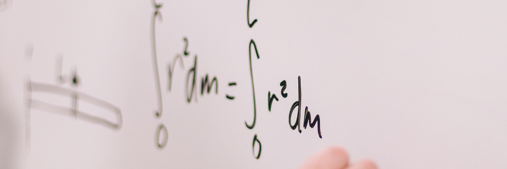 a mathematical formula is written on a white board