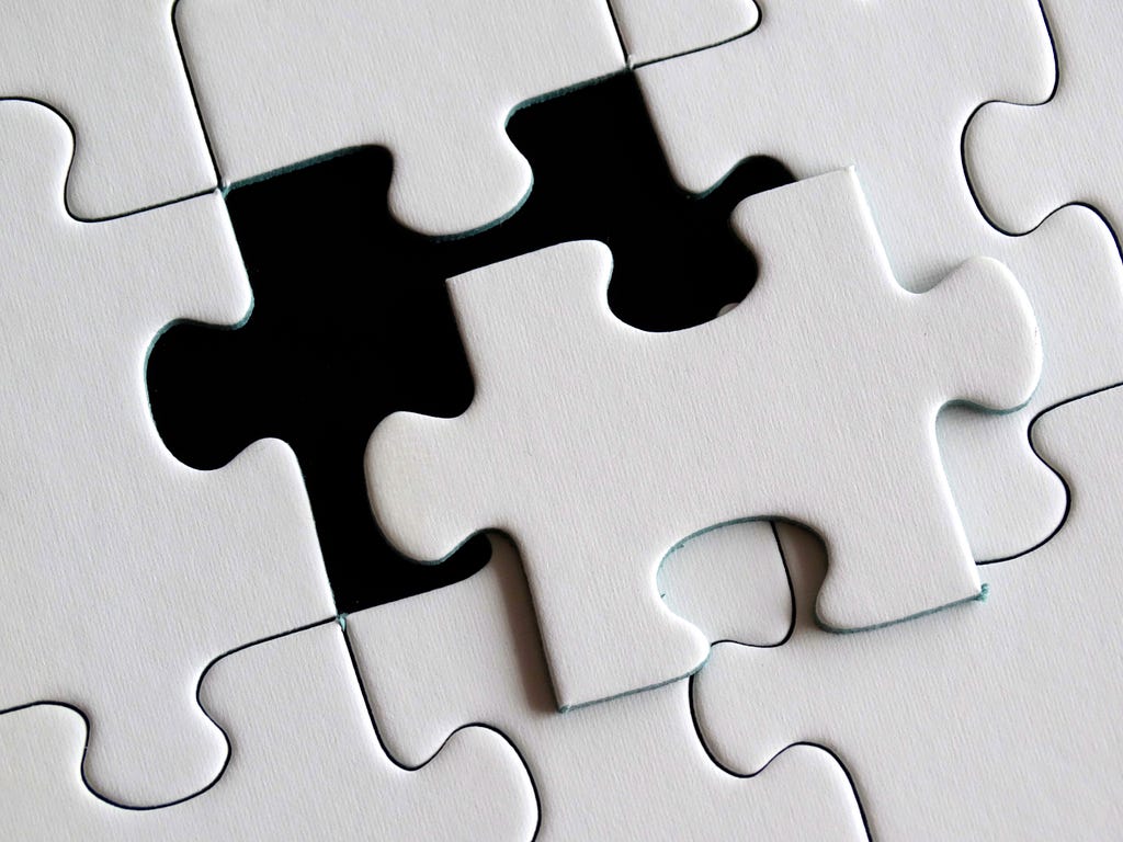 This image shows a white puzzle piece falling into place.