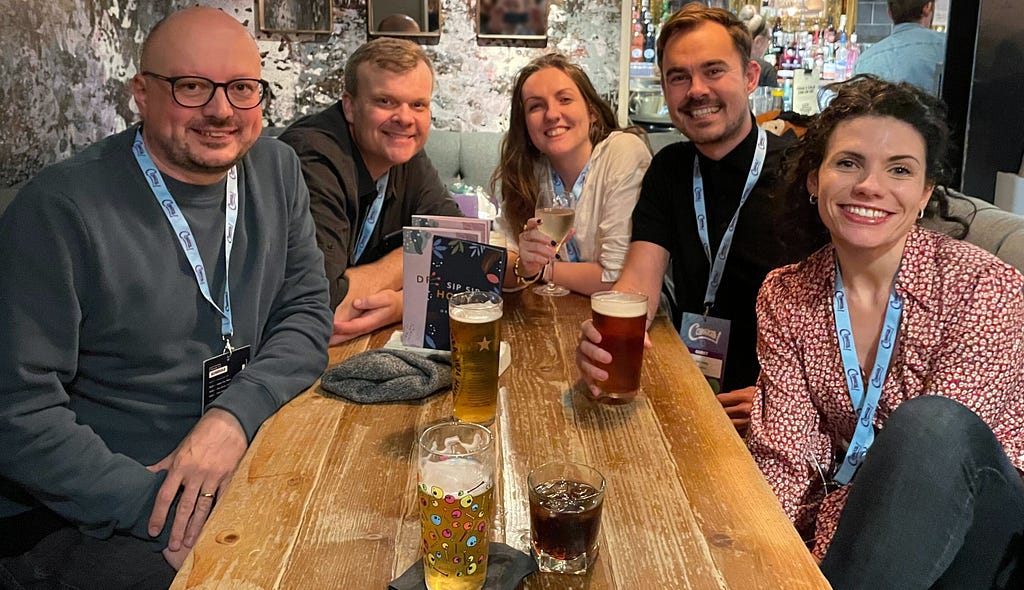 A photograph of team mates enjoying a drink together after Canvas conference