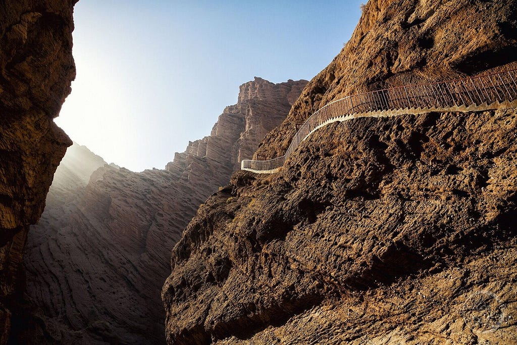 Picture of a long set of stairs up the side of a mountain that looks impossible to climb.