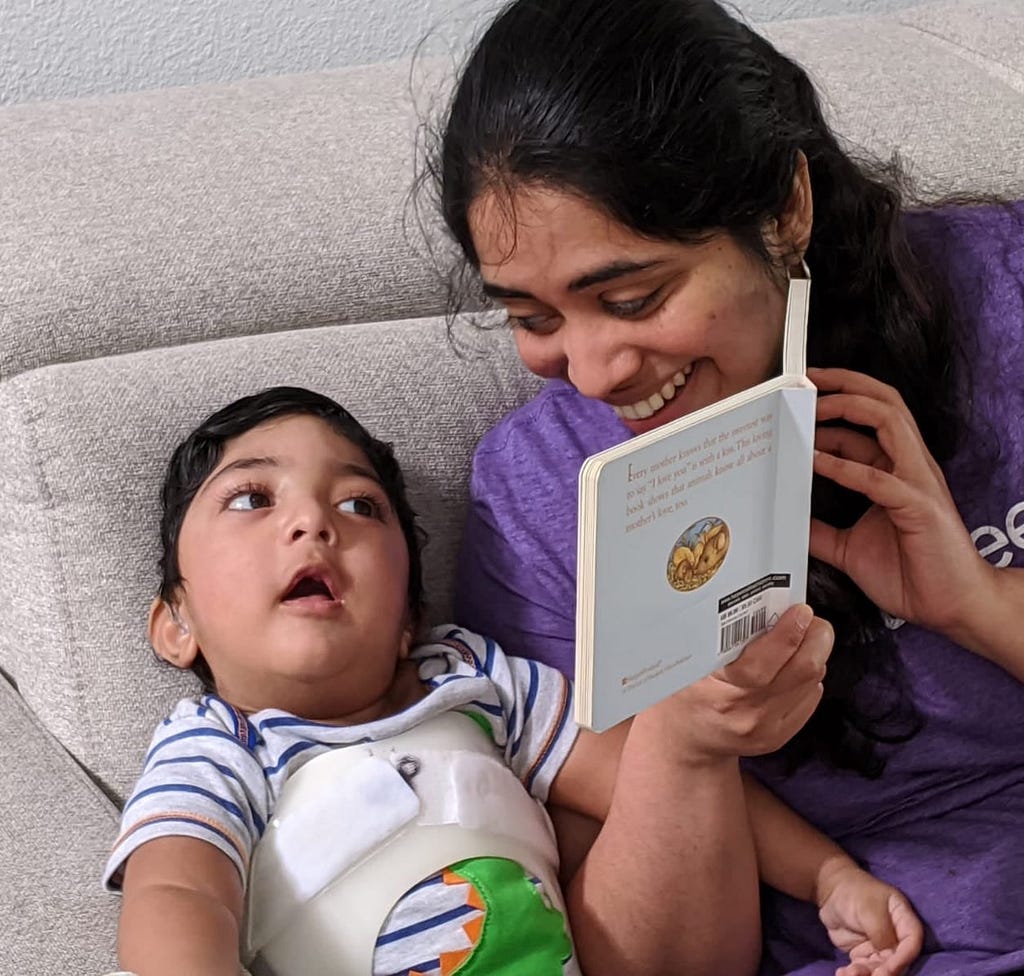 Ramya reads a book to her son, Raghav.