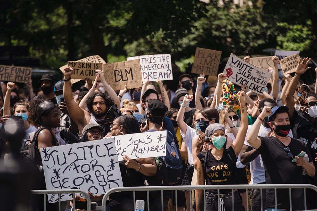 Group of Black Lives Matter protesters holding signs