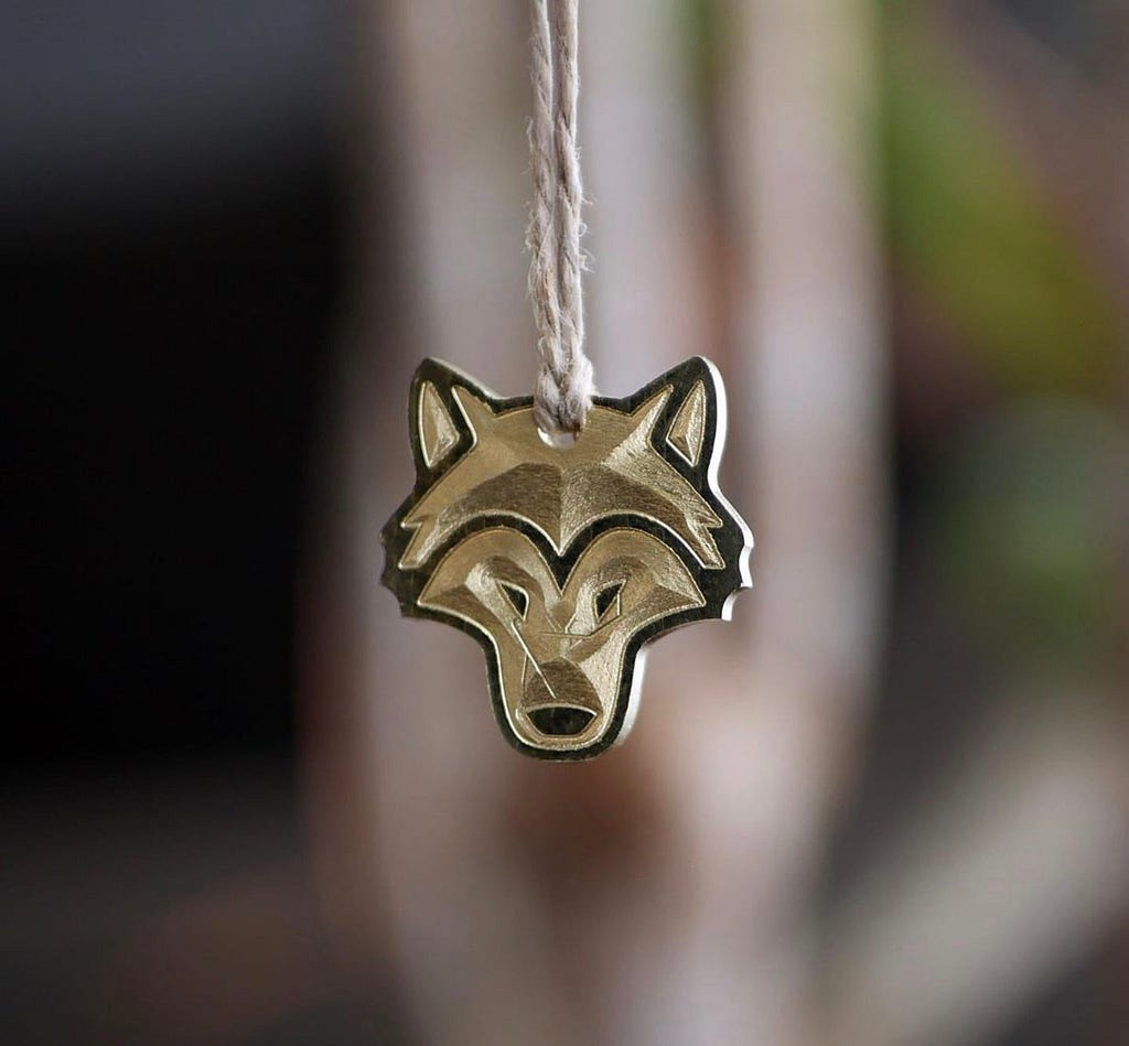 Brass wolf pendant Joel CNC machined.