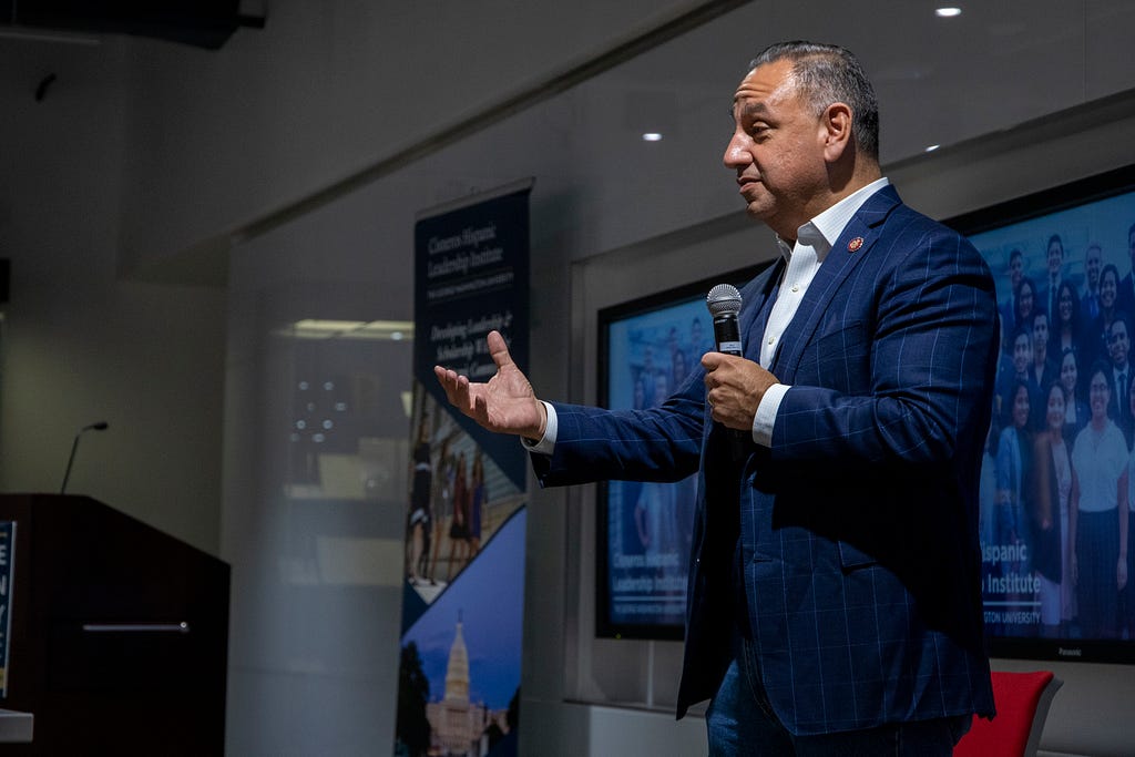 Congressman Gil Cisneros talks to the Cisneros Hispanic Leadership Institute Scholars