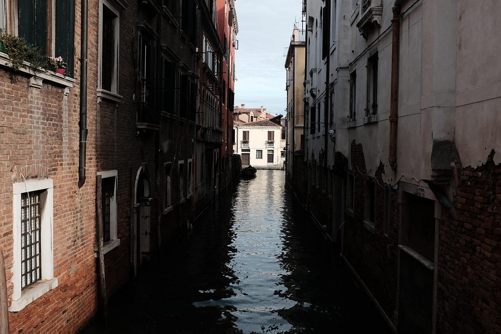 shadowy water canal in Venice, Italy