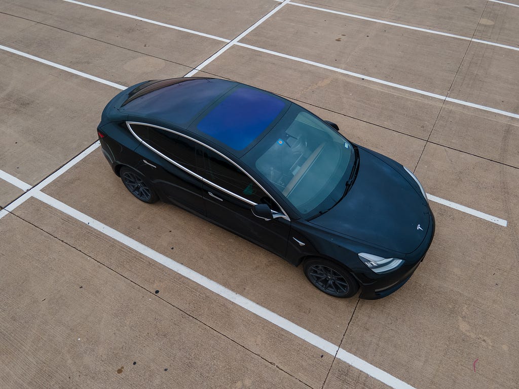 Black Tesla Model 3 in a parking lot