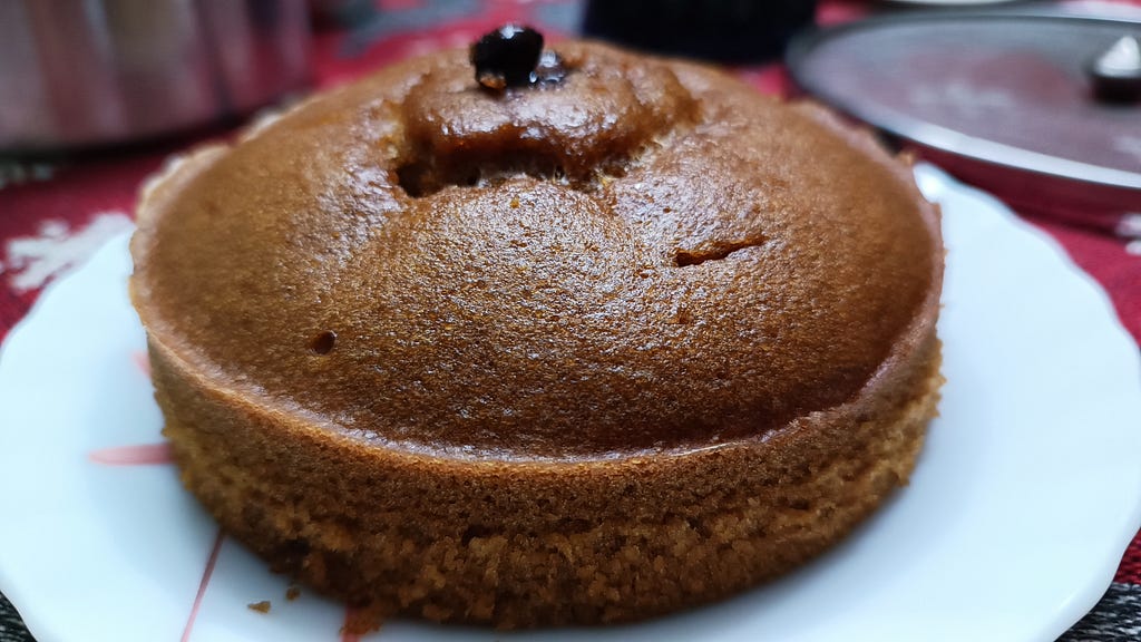 A multigrain flour-organic jaggery cake with a dash of hazelnut essence and choco-coated coffee beans from my oven [Photo by author]