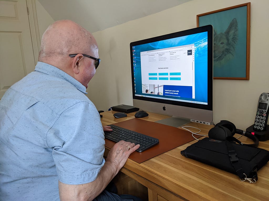 A man with visual impairments uses a screen reader to test a website in his home.