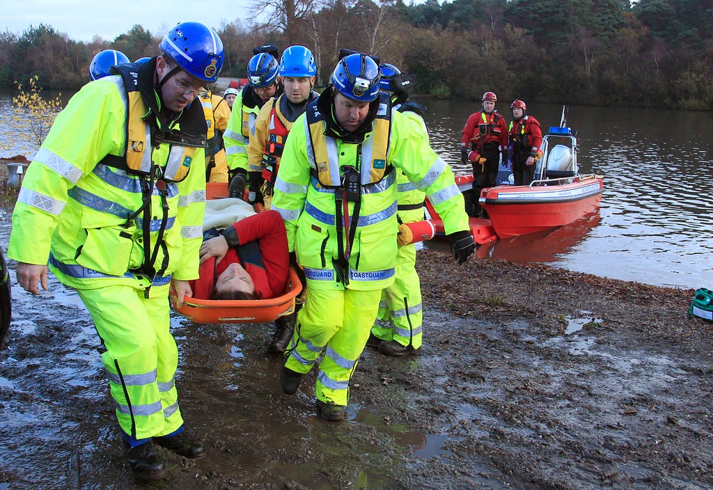 Emergency services workers rescue volunteers posing as flood victims during an exercise on flood response in Surrey, England, November 18, 2010. Photo by Luke MacGregor/Reuters